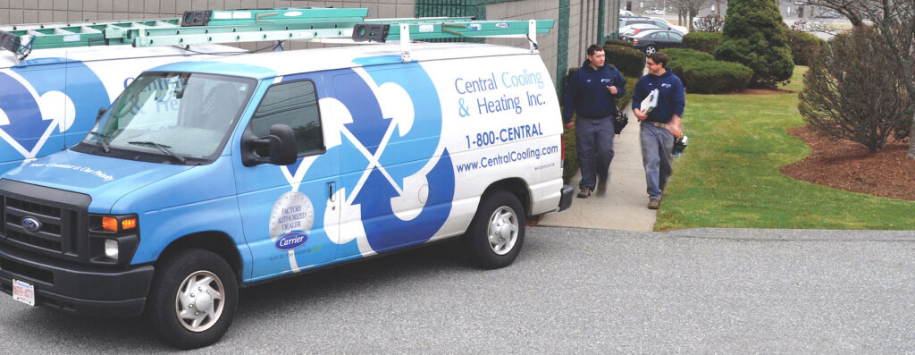 Two Central, factory authorized salesmen walking to their work vans on their way to install a new residential HVAC system