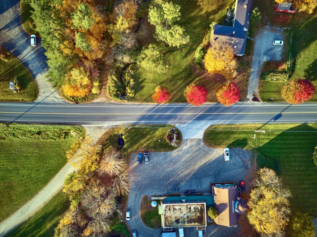 An aerial view captures a road intersecting a residential area of Boxford, MA.